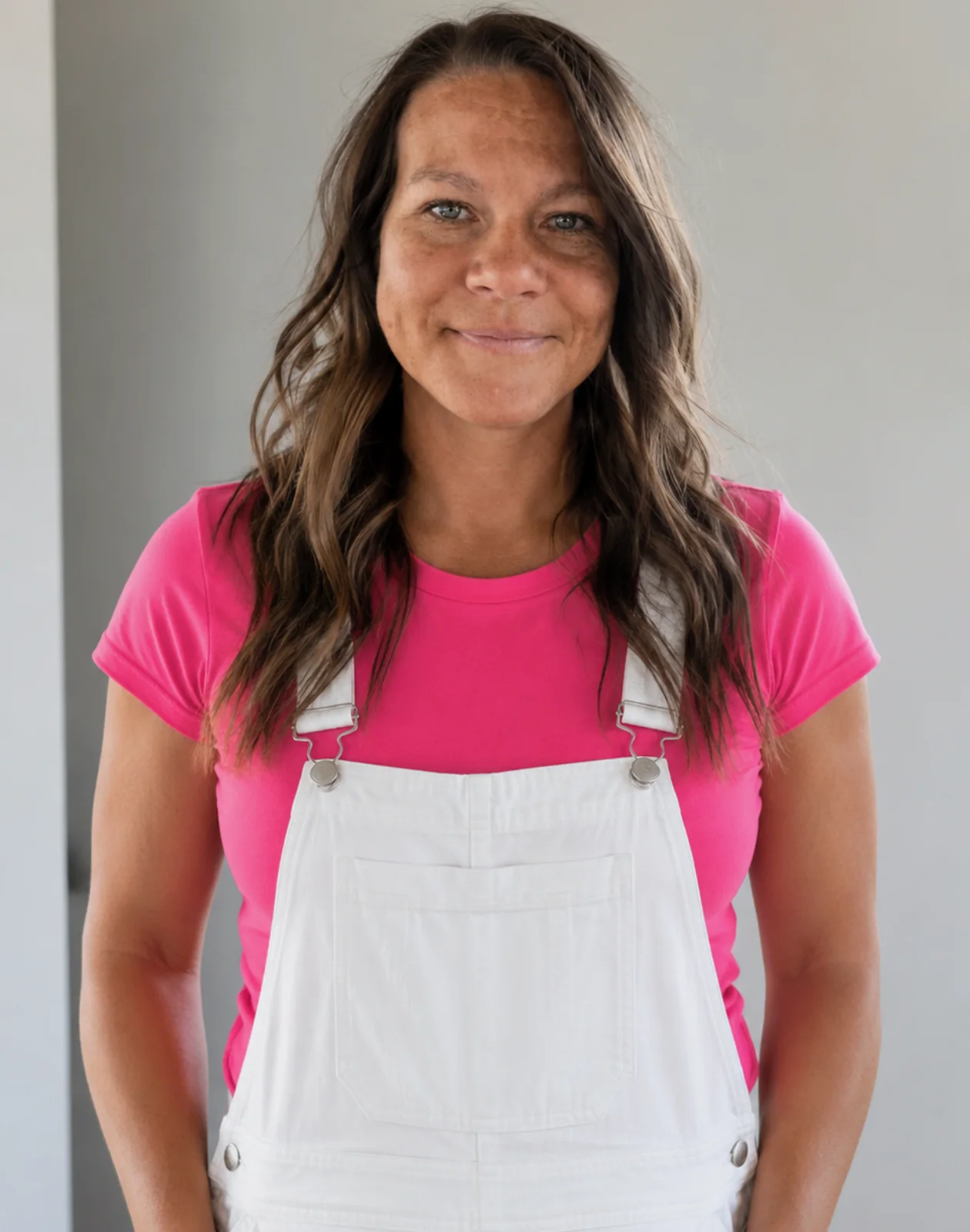 Abby, owner of Home Touch Finishing, in her work overalls